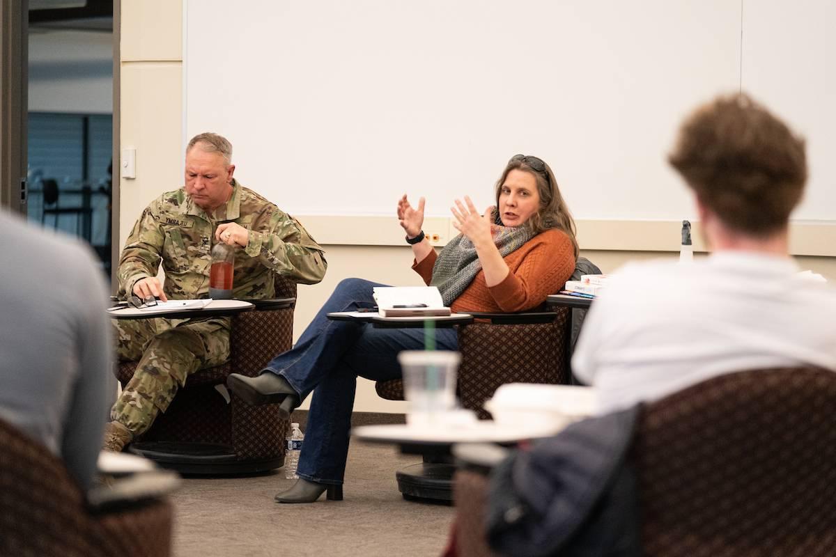 Students talking, one in army uniform